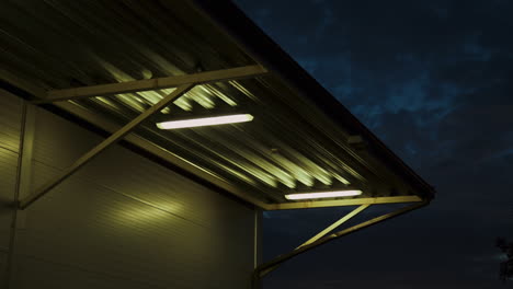 Exterior-view-of-warehouse-eaves-and-sidewall-illuminated-with-industrial-lights