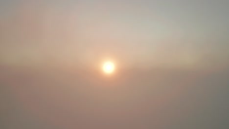 Aufsteigende-Antenne-Aus-Nebel,-Die-Einen-Lebendigen-Sonnenaufgang-über-Der-Bergkette-Enthüllt