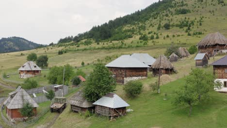 Amazing-traditional-old-Serbian-cottage-village,-Ticje-Polje-on-hillside,-aerial