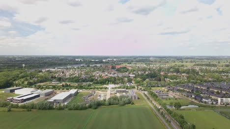 Aerial-drone-shot-of-flying-up-at-the-suburban-and-busy-road-in-the-Netherlands