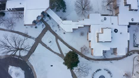 Aerial-top-down-shot-of-academic-school-campus-covered-in-fresh-winter-snow