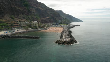 Flying-over-Atlantic-Ocean-seawall-towards-Areia-Beach-in-Madeira