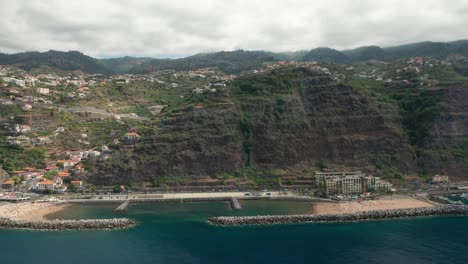 Aerial-of-steep-rock-face-of-volcanic-Island-Madeira-during-cloudy-day