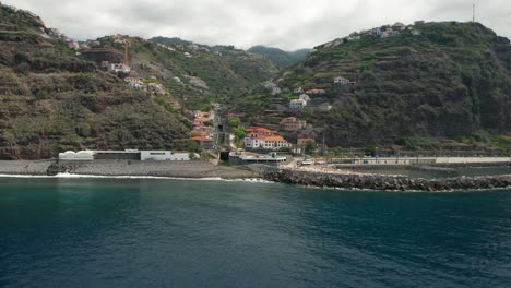 Aerial-of-coastal-village-Calheta-on-rugged-volcanic-island-Madeira