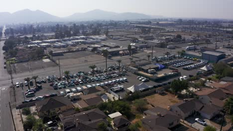 Panning-aerial-shot-of-an-industrial-community-on-a-hazy-day-in-the-Inland-Empire-with-the-10-Freeway-in-the-background
