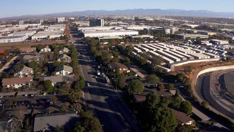 Aerial-wide-shot-of-a-South-Bay-industrial-neighborhood-with-Downtown-Los-Angeles-far-in-the-distance