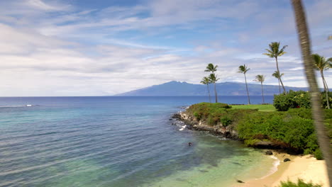 Aerial-view-of-golden-sand-beach-and-rocky-coast-on-Maui-Island,-Hawaii