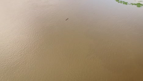 Aerial-view-of-a-tiny-indigenous-canoe-cruising-the-Orinoco-River-Delta