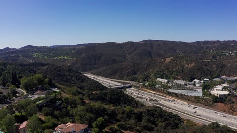 Wide-aerial-panning-shot-of-the-405-Freeway-cutting-through-the-Sepulveda-Pass