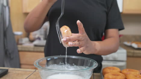 Woman-glazing-homemade-donut-over-glass-bowl-in-kitchen,-Slow-Motion-Closeup