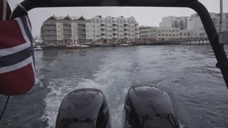 Motorboat-speeding-with-Norwegian-flag-waving-at-Lofoten