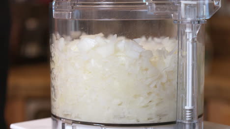 Pulsing-the-food-processor-to-produce-perfectly-chopped-onions-for-a-homemade-recipe