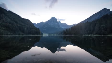 Sunset-time-lapse-of-lake-Obersee-in-Glarus,-Switzerland-with-a-summer-glow-and-calm-reflection