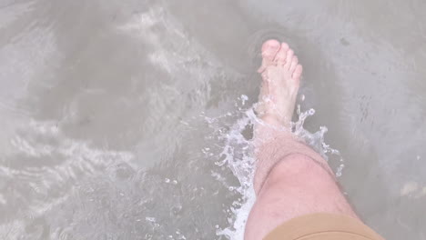 Man-Barefoot-in-Shorts-Walks-in-the-Clear-Shallow-Salt-Lake-Water-in-Utah