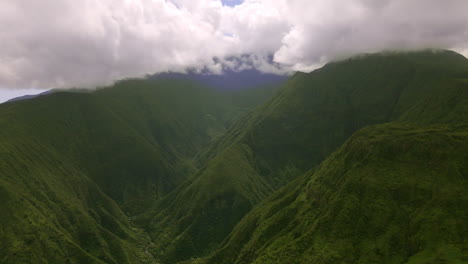 Peak-of-green-rainforest-mountain-in-clouds,-Maui-island,-Hawaii,-aerial-view