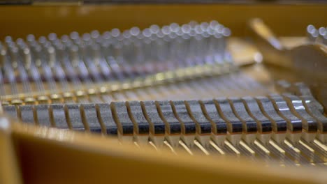 Close-up-of-hammers-of-an-open-concert-grand-piano-moving-during-a-recording-session-in-a-studio-Racking-Focus