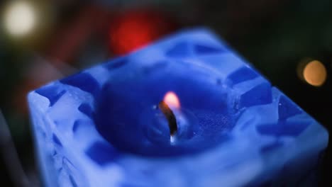 Eine-Brennende-Blaue-Kerze-Wirbelte-In-Einem-Weihnachtskranz