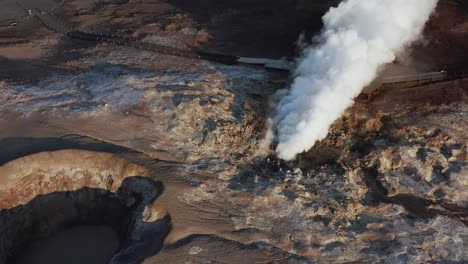 Thick-steam-rises-from-volcanic-fumarole-in-wild-Icelandic-landscape,-Gunnuhver