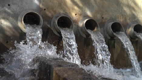 Clear-Water-Flows-Through-Row-of-Waste-Pipes---Slowmo-Footage