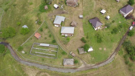 Aerial-shot-rising-up-and-circling-a-tiny-remote-village-in-Serbia-on-the-Pester-Plateau