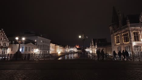 Static-wide-shot-of-St-Michaels-Bridge-with-walking-people-during-night
