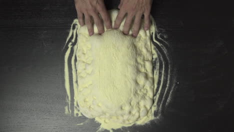 Slow-motion-of-baker-stretching-pizza-dough
