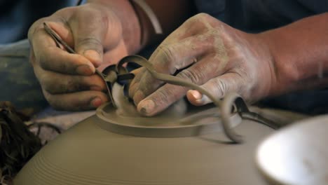 Worker-in-pottery-studio-using-pottery-wheel,-handmade-ceramics