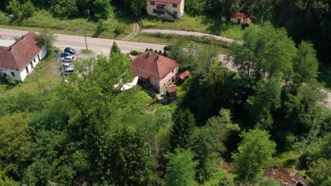 Sky-View-Of-Lush-Green-Trees-Surrounding-The-Ticje-Polje-Peaceful-Village-In-Jadovnik-Mountain-Prijepolje-Serbia-During-Daytime---Aerial-Shot