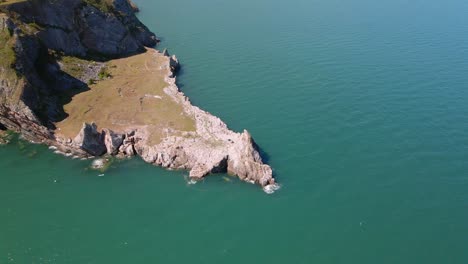 Aerial-circling-shot-of-coastal-promontory-named-Long-Quarry-Point-in-Torquay,-Devon,-England
