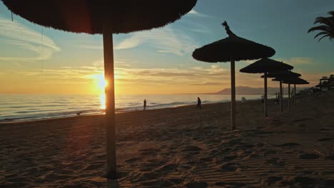 Sunset-view-at-the-beach-behind-resort-parasols