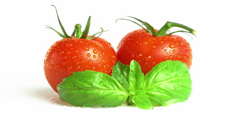 Dos-Tomates-Cherry-Rojos-Con-Hojas-De-Albahaca-Y-Gotas-De-Agua-Aisladas-En-El-Fondo-Blanco