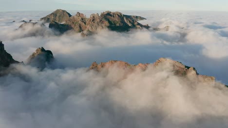 Wild-mountains-of-Madeira-covered-by-clouds,-crazy-weather-pattern,-aerial