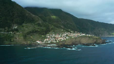 Traditional-village-Seixal-on-wild-coast-of-Madeira-island-with-majestic-cliffs