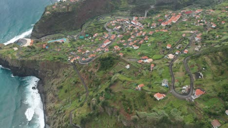 Casas-Tradicionales-De-Techo-Rojo-En-La-Empinada-Ladera-Verde-De-La-Isla-Volcánica-De-Madeira