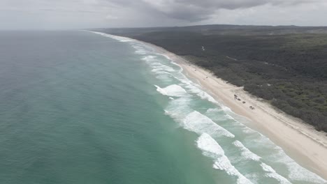 Aerial-View-Of-White-Sand-Beach-And-Ocean-Waves-In-North-Stradbroke-Island---Main-Beach-Headland-Reserve-In-Point-Lookout,-QLD,-Australia
