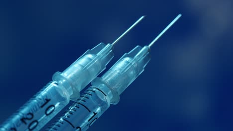 Two-syringes-for-vaccination-or-medical-treatment---macro-focus-pull-along-the-syringe-to-the-tip-of-the-needle