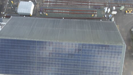Aerial-jib-up-of-solar-panels-on-the-side-of-industrial-rooftop
