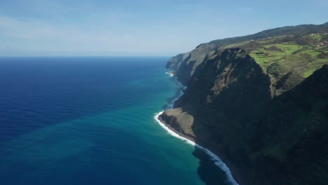 Stunning-blue-Atlantic-Ocean-meeting-steep-rocky-cliffs-of-Madeira-island