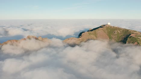Aerial-of-low-hanging-clouds-covering-part-of-idyllic-Madeira-Island