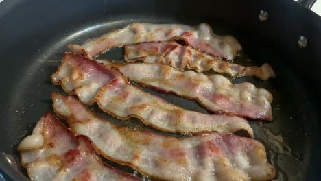 Bacon-Cooking-on-stovetop-in-kitchen