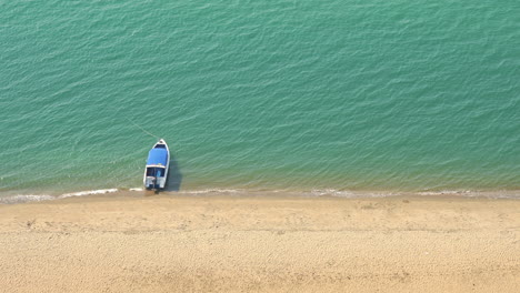 Anchored-boat-on-seashore.-High-angle-static-shot