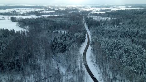 Aerial-View-Of-snow-covered-Forest-Road-in-Poland