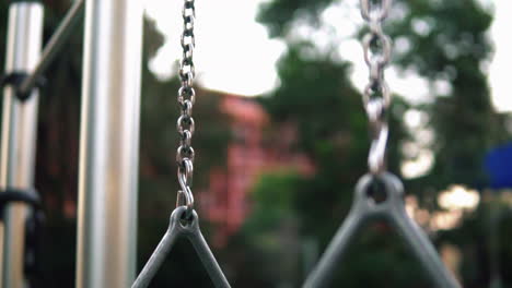 Close-Up-Of-Steel-Triangular-Gymnastic-Rings-Hanging-In-An-Outdoor-Gym,-selective-focus