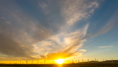 Wind-turbines-in-the-foreground,-cloudscape-overhead-in-this-stunningly-colorful-sunset-time-lapse