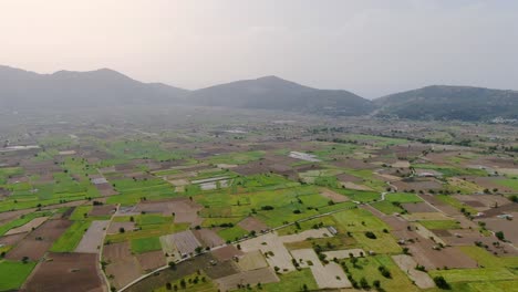Slow-Aerial-Dolly-Over-Agriculture-Farm-Fields-In-Lastihi-in-Crete