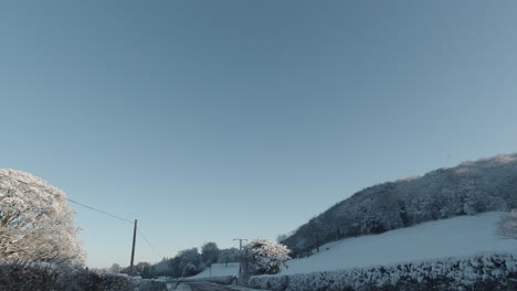 Driving-snowy-white-rural-snow-covered-countryside-frosted-landscape-wilderness-POV