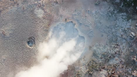 Slow-motion-of-bubbling-mud-pool-with-steam,-volcanic-Iceland,-aerial