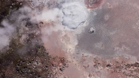 Unique-volcanic-landscape-in-Iceland-with-large-bubbling-mud-pool,-aerial