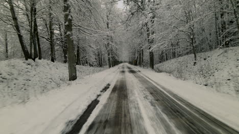 Travel-Through-Country-Road-In-Snowed-Winter-Forest-Near-Pieszkowo-Village,-Poland