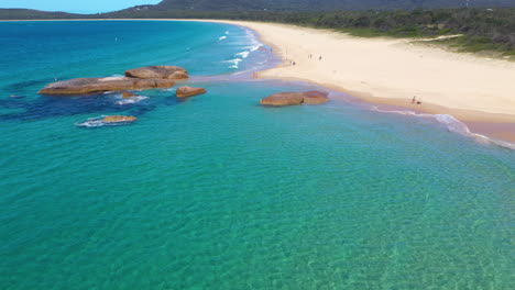 Aerial-shot-of-sunbathers-on-tropical-New-South-Wales-Australian-beach